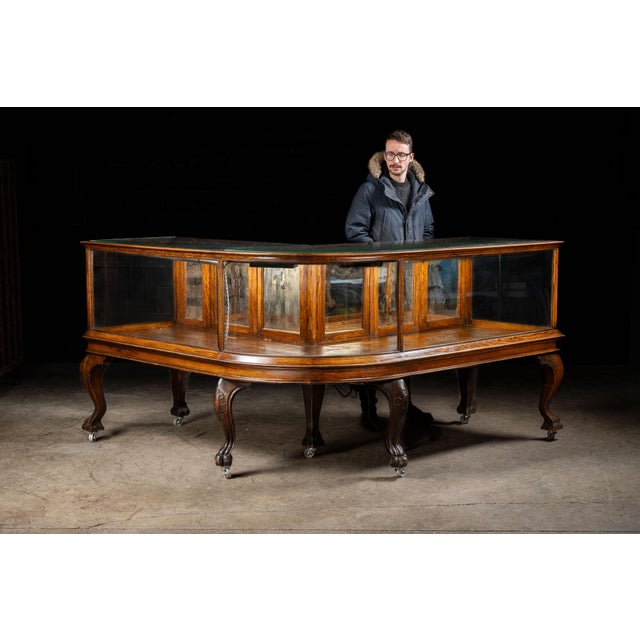 Antique wood and glass vitrine. The gorgeous oak woodwork starts at the top and extends down its clawfoot cabriole legs....