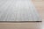 A hand-knotted wool rug, made in India and measuring 9' x 12'. Geometric drawing - repeating motifs held inside strong...