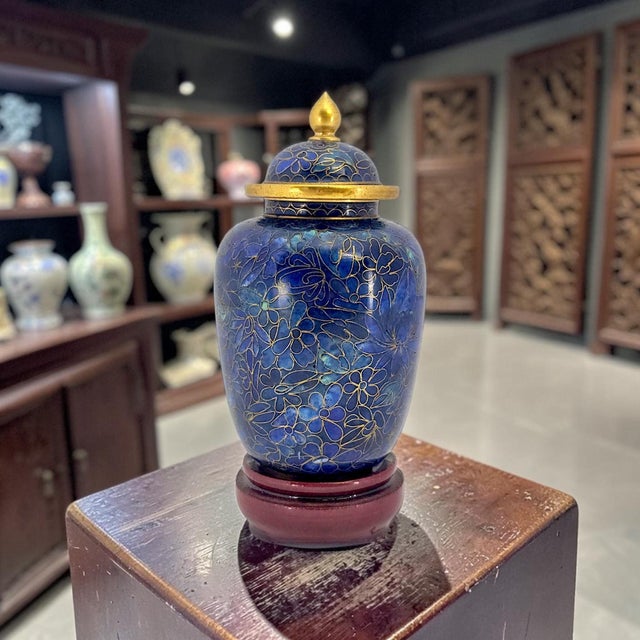 A miniature lidded cloisonné ginger jar with separate stand, produced by the Beijing Enamel Factory under its Jingfa...