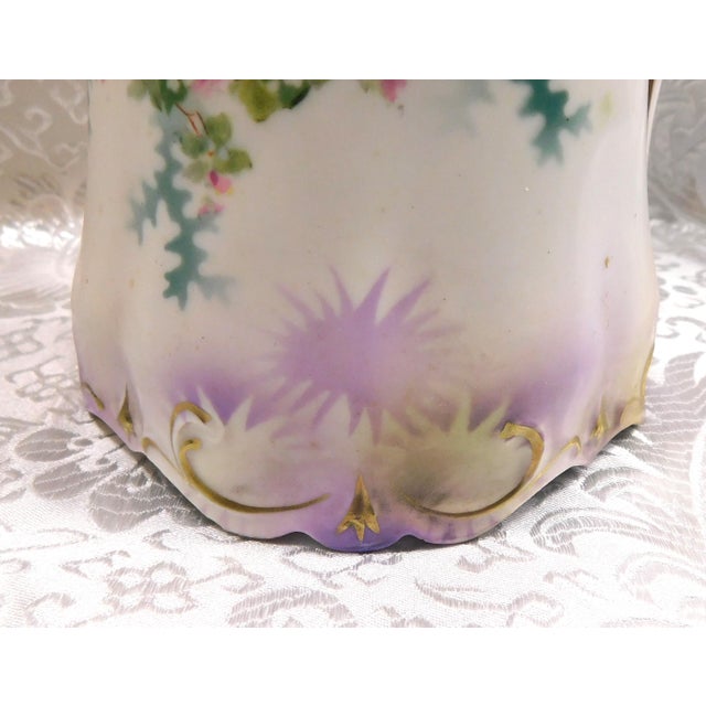 This is a slender Reinhold Schlegelmilch RS Prussia chocolate pot in white with pink flowers, purple trim and a beaded...