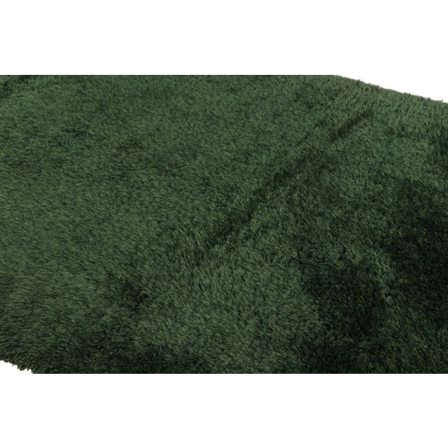 Hand-knotted in lush, high-pile wool in Sweden circa 1960-1970, this 6x9 vintage Swedish Rya rug is a bold new addition to...