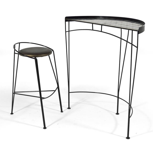 This terrific post-modern design by Vecta uses wire rod for a strong graphic quality. It features a semi-circular table...
