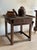 A primitive French cobbler's bench worn nearly black from a century of work, the plank top scarred and waxed deep, with a...