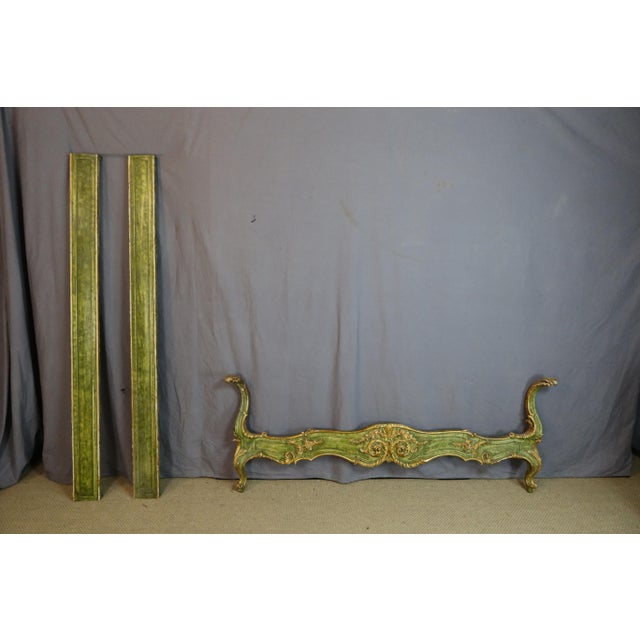 A gilded and painted wooden bed carved with rosettes, an italian work from the 20th century. This bed can be used as a...