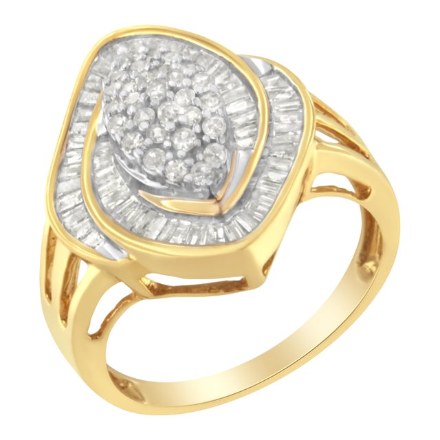 Two half spirals inlaid with baguette cut diamonds raise from the ring to encapsulate a round cut diamond cluster. A 10k...
