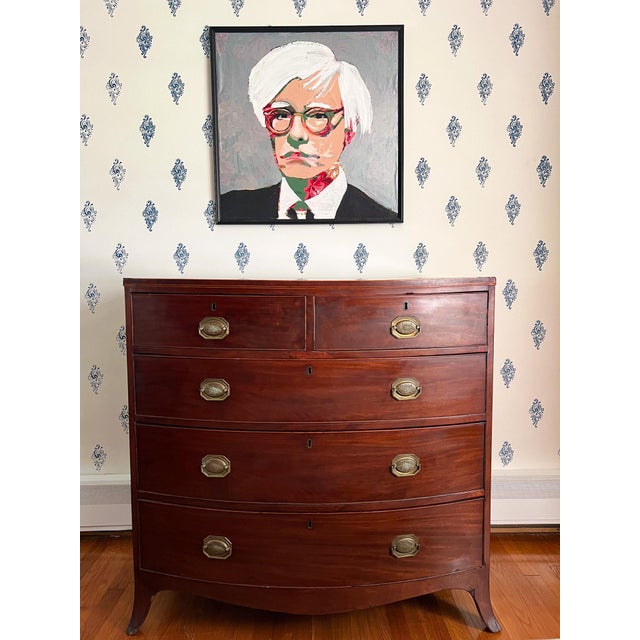 With beautifully figured mahogany, sweeping French bracket feet, and delicate string inlay, this bow front chest of...