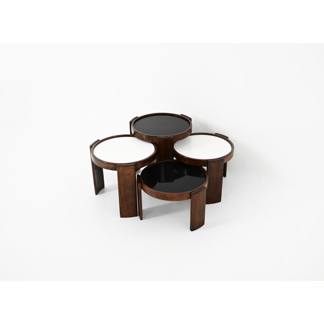 Wooden nesting table. Reversible black and white top. Stamped Cassina. Wear due to time and age of the table. Measures:...