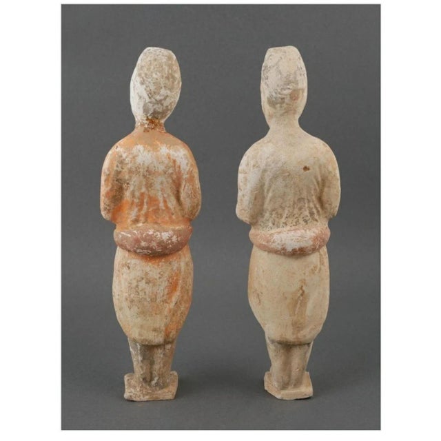 Description: Pair of Tang period terracotta horse grooms from the private collection of Dr. Bron Lipkin, one with much of...