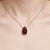 Timeless and elegant, this refined necklace features a striking solitaire gemstone that radiates rich color and classic...