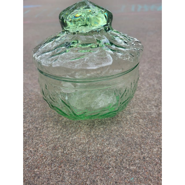 This green 1970s glass candy dish or trinket box is 5" tall with a 4 3/4" diameter. The lid makes this very functional.