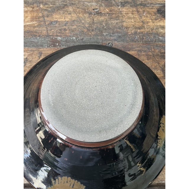 This striking vintage studio pottery bowl is a masterclass in mid-century organic modernism, featuring a bold abstract...
