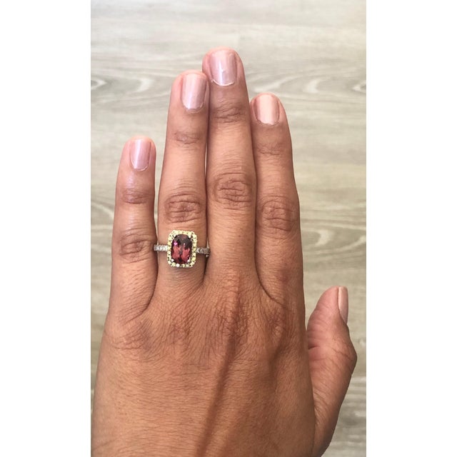 This ring has a 2.43 carat Oval Cut Tourmaline and is surrounded by 22 Yellow Sapphires that weigh 0.44 Carats as well as...