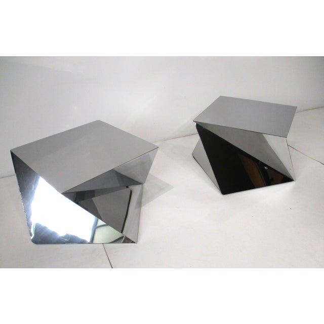 A pair of stunning sculptural angled polished chromed side tables in the style of origami folds that would make a...