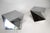 A pair of stunning sculptural angled polished chromed side tables in the style of origami folds that would make a...