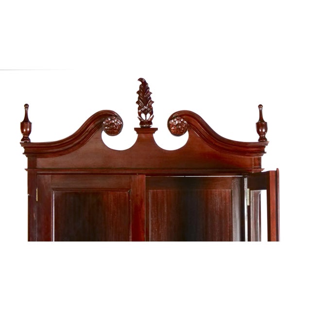 Early 20th century mahogany wood frame and glass display cabinet with two adjustable glass shelves. The cabinet features...