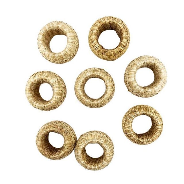 Elevate your entertaining with this set of 8 handwoven jute napkin rings, designed to bring organic elegance and...