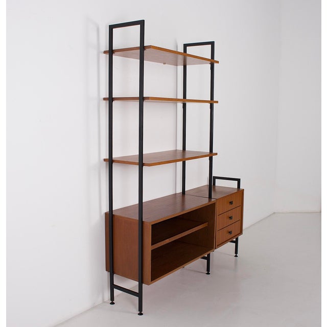 Teak and black metal wall shelf, 1960s. This shelf is modular, both in terms of the shelves and the drawers. Adjustable...
