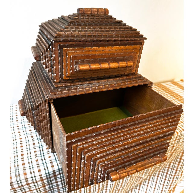 This box is a vintage American folk art piece commonly known as “Tramp Art,” likely created in the late 19th or early 20th...