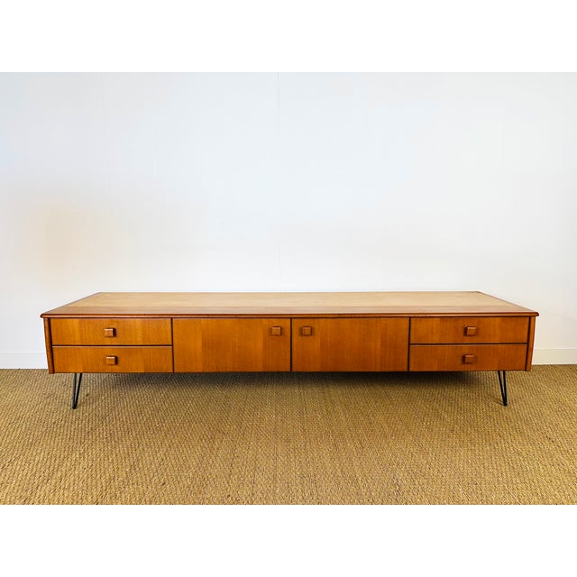 A magnificent vintage sideboard with a scandinavian design from the 1960s, characterized by its long, low lines, typical...