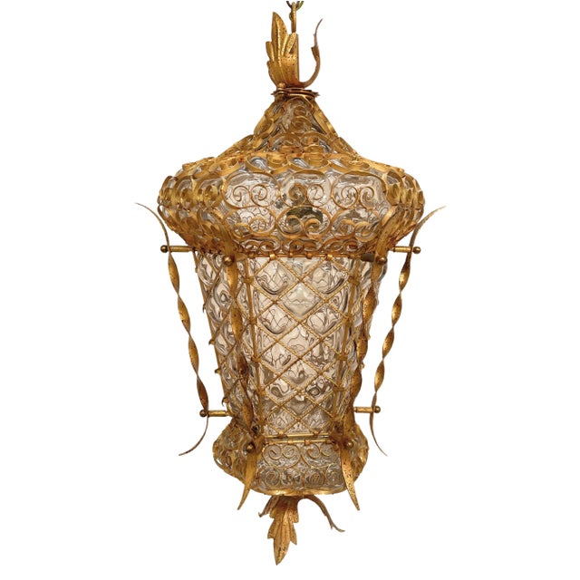 Incredible Venetian lantern in blown glass perfectly and symmetrically in the golden wrought iron structure. This...
