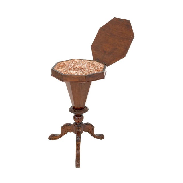 Victorian Walnut Trumpet Sewing Table, with octagonal lift top and parquetry trim opening to divided interior terminating...