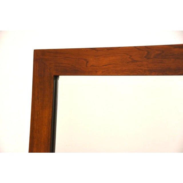 A mid century modern rosewood framed mirror. Comes with dresser mounting brackets