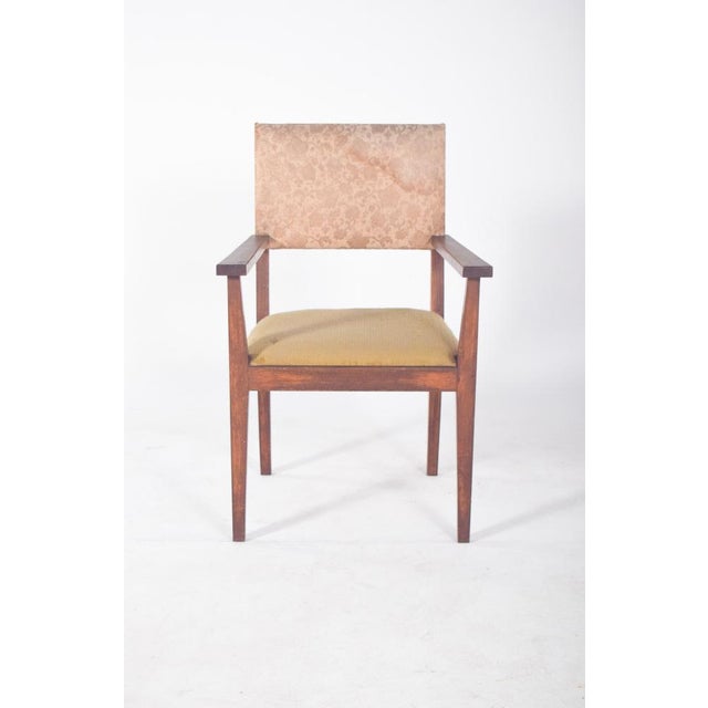 Armchair with upholstered seat and back. With typical mid-century modernist design, it has straight lines, a functional...