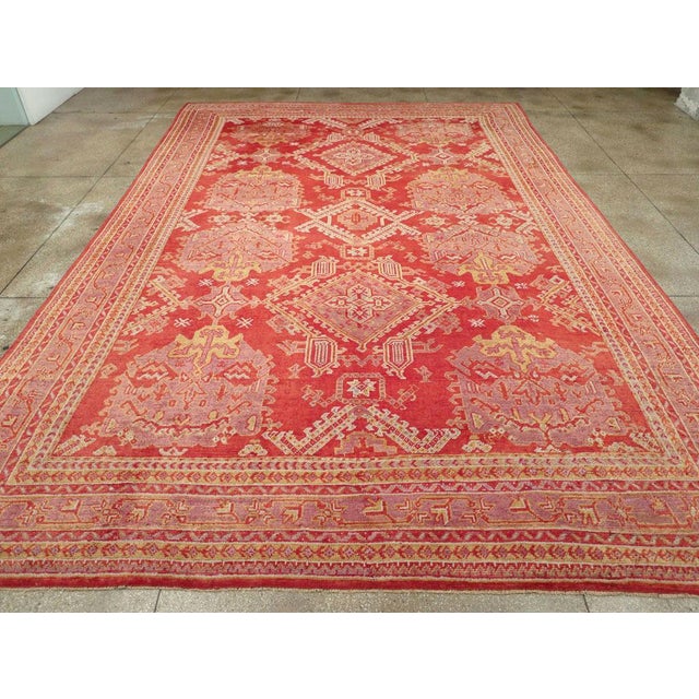 An antique Turkish Oushak large carpet handmade during the Early 20th century. Measures: 11' 11" x 17' 9"
