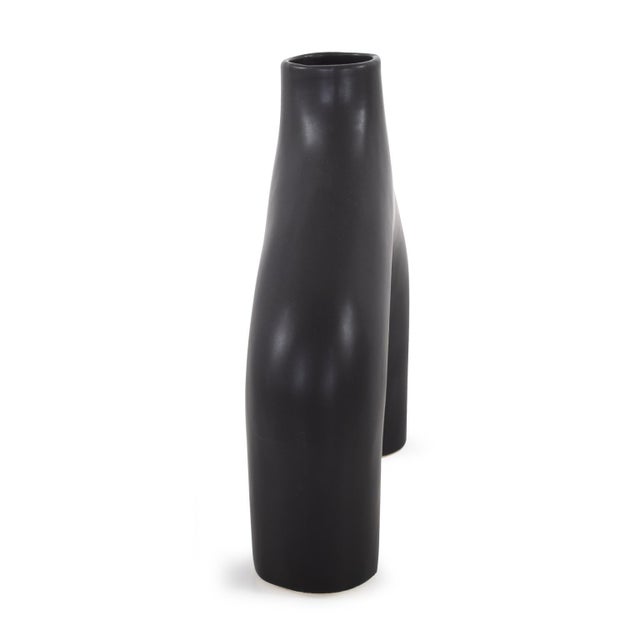This unique vase features an irregular shape that plays with asymmetry and balance, setting it apart from traditional vase...