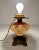 An antique brass oil lamp, converted to electric, with a handpainted glass middle. Looks particularly lovely with the...