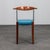 A striking set of four italian postmodern dining chairs combining warm cherrywood, stainless steel and vibrant blue...