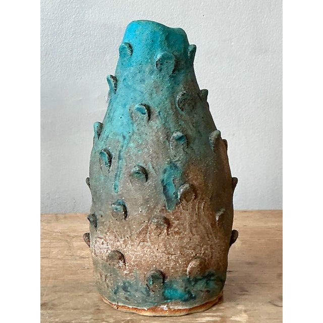Embrace the organic beauty of nature with this captivating vintage studio pottery vase, artistically designed to resemble...