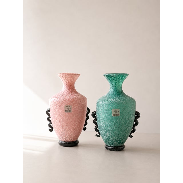 This exceptional pair of Murano glass vases evokes the classic shape of ancient Roman amphorae Meticulously handcrafted by...