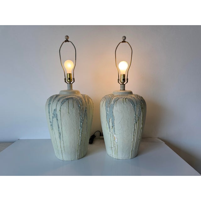 A striking pair of 1980’s vintage ceramic table lamps, hand-painted with an organic abstract drip design. Each lamp...