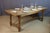 Mid-20th century oak dining table. The four legs are joined by a stretcher. Good condition. Signs of wear on the tabletop....