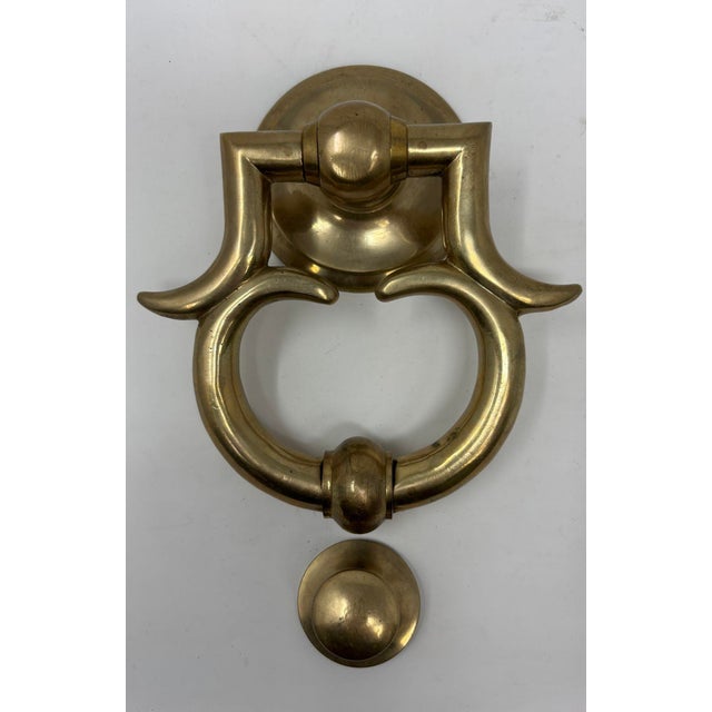 A large solid cast polished brass door knocker sophisticated in shape and design. A substantial Georgian style early...