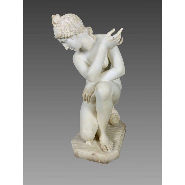 Early 19th-century white marble sculpture in the Neoclassical style depicting Venus at the Bath For Sale