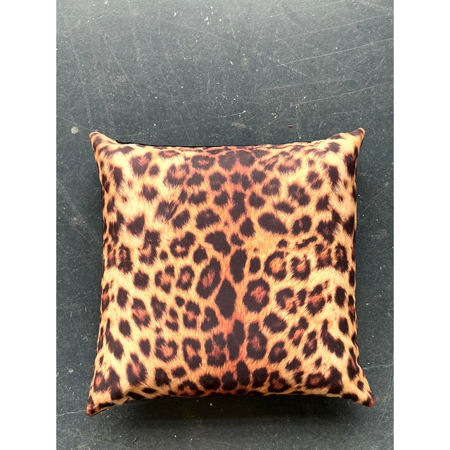Elevate your seating arrangement with this striking vintage leopard print throw pillow, a perfect marriage of Hollywood...