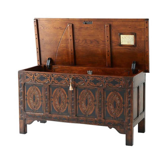 An early English style oak blanket chest, the moulded edge top, above a panelled back and sides, the front carved with...