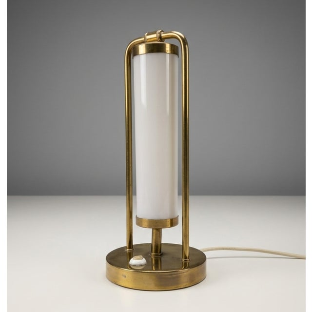 A compact Bauhaus-style table lamp produced in former Czechoslovakia during the 1930s. The design combines a tubular brass...