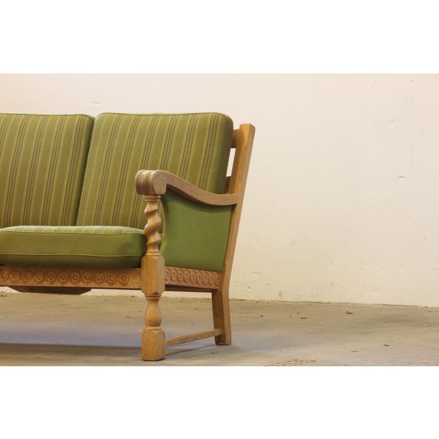 A beautiful 3-seater sofa resembling the style of Henning Henry Kjærnulf, forms a rare sculptural find. This sofa, crafted...