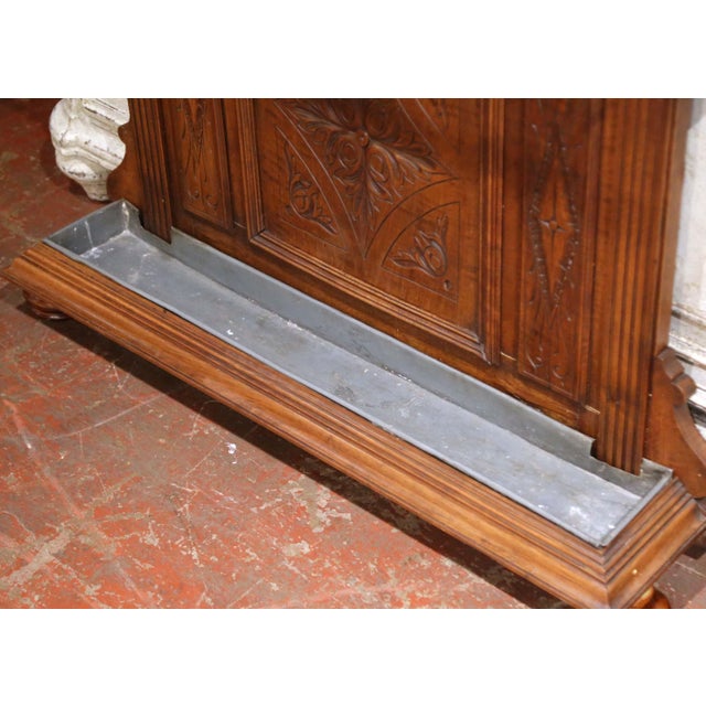This handsome antique hall tree combines practical storage with the architectural character of the French Henri II style....