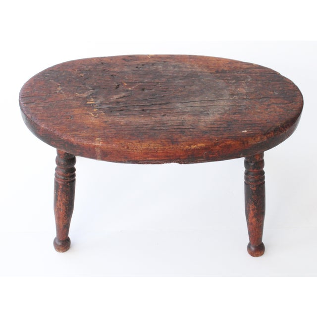 19th Century Petite English hand carved footstool with time worn distressing throughout. Made of solid hardwood. We...