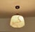 Art Deco pendant lamp from the 1930s, stepped Ivory glass shade mounted on a brass and bakelite suspension, the bakelite...