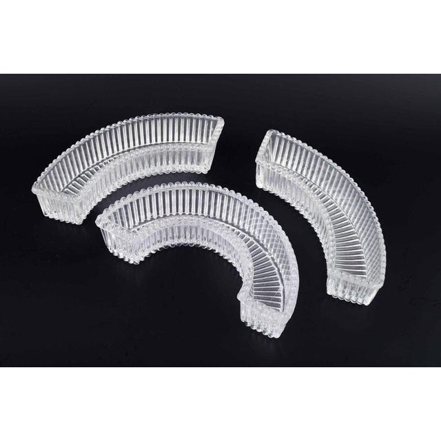 Baccarat, three curved glass trays. A set of three curved glass trays made of clear pressed crystal. Decorated with...