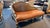 Large ornate chaise sofa in an umber color cushion. The wooden frame is set in a silver and gold like paint. The style has...