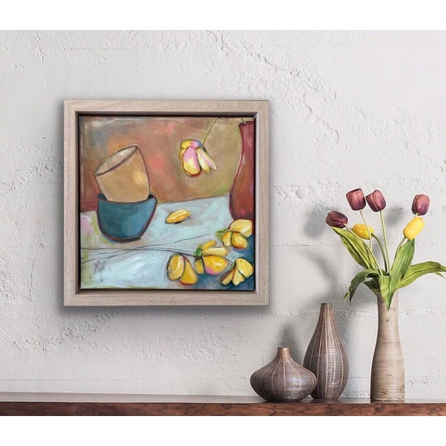 This artwork presents a still life composition featuring a tipped-over vessel and scattered yellow flowers, creating a...