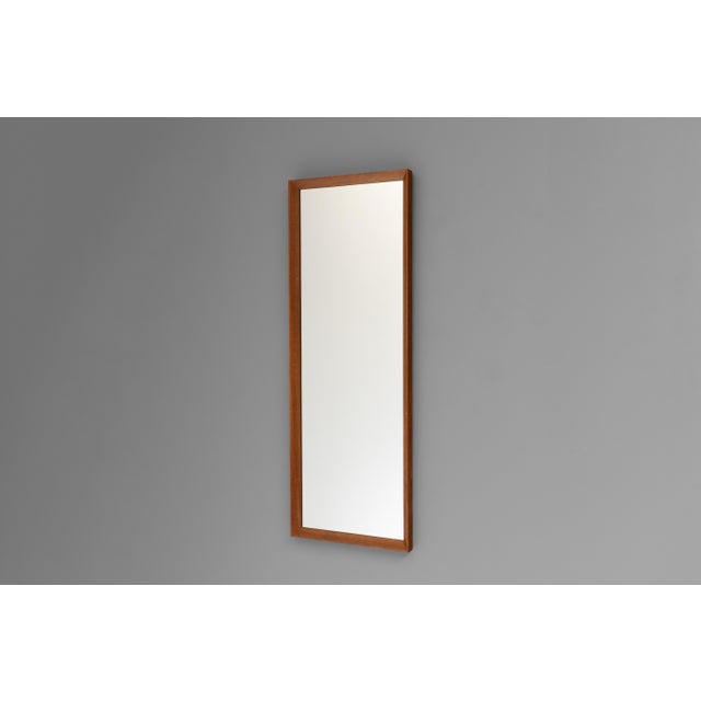 Narrow mid-century bevelled edge teak tapered mirror. U.K circa 1960.