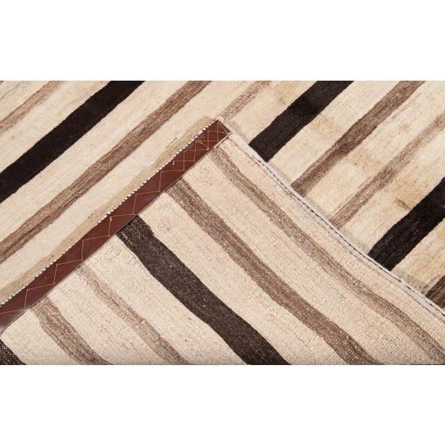 Beautiful Contemporary Persian Gabbeh Hand-knotted Wool rug with a beige field. This Gabbeh rug has brown accents in a...