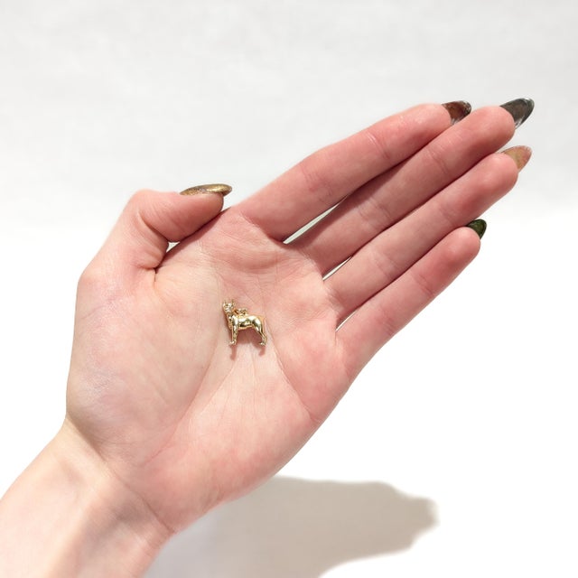 A fine vintage figural gold charm. In 14 karat yellow gold. In the form of a boxer dog. With an integral bail and jump...